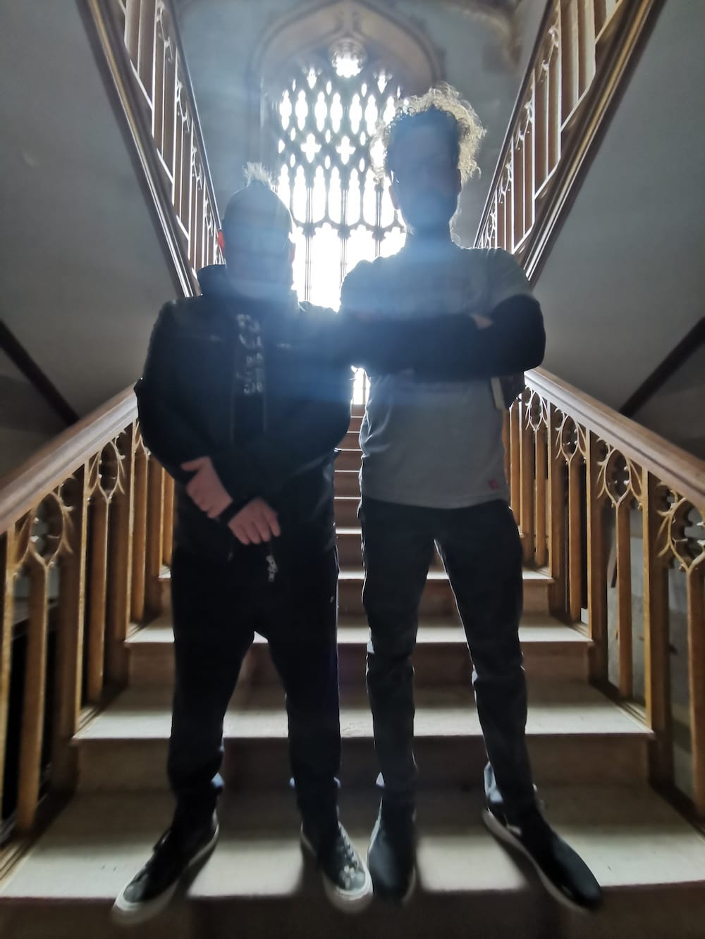 Simon and Kelly standing on castle stairs with ornate railing